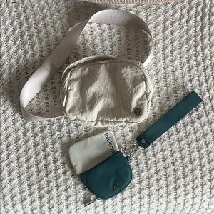 Lululemon cream/white belt bag and Teal/green coin wristband.